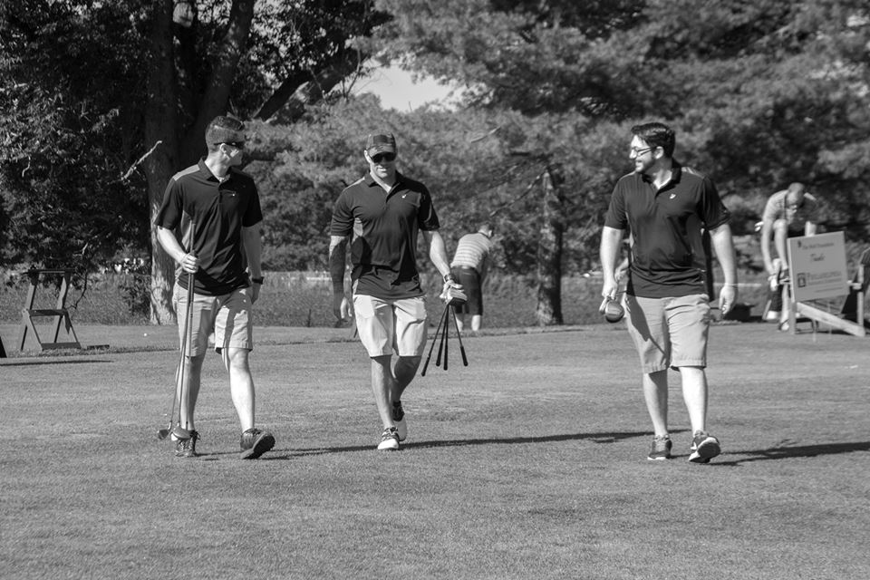 Three veterans golfing on the golf course