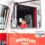 Little boy in a fire truck at the autism awareness fair