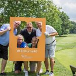 5 men posing in CDS turns 40 golfing tournament sign