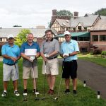 Four men out of golf course during golfing tournament