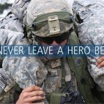 Solider with another solider on their back with the words "we never leave a hero behind" written on the screen